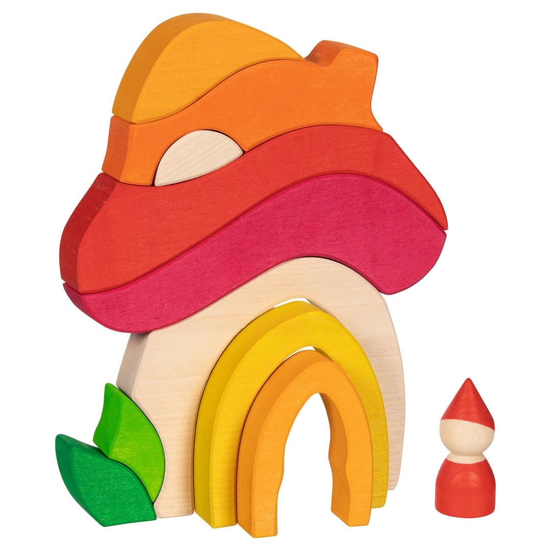 Goki evolution wooden building shapes toy forming a mushroom house with a small figure