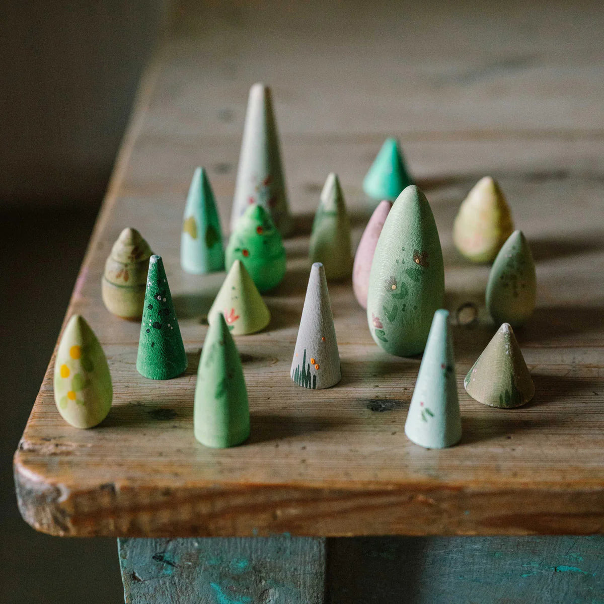 grapat wooden toy trees playset, colorfully hand-painted and set on a table