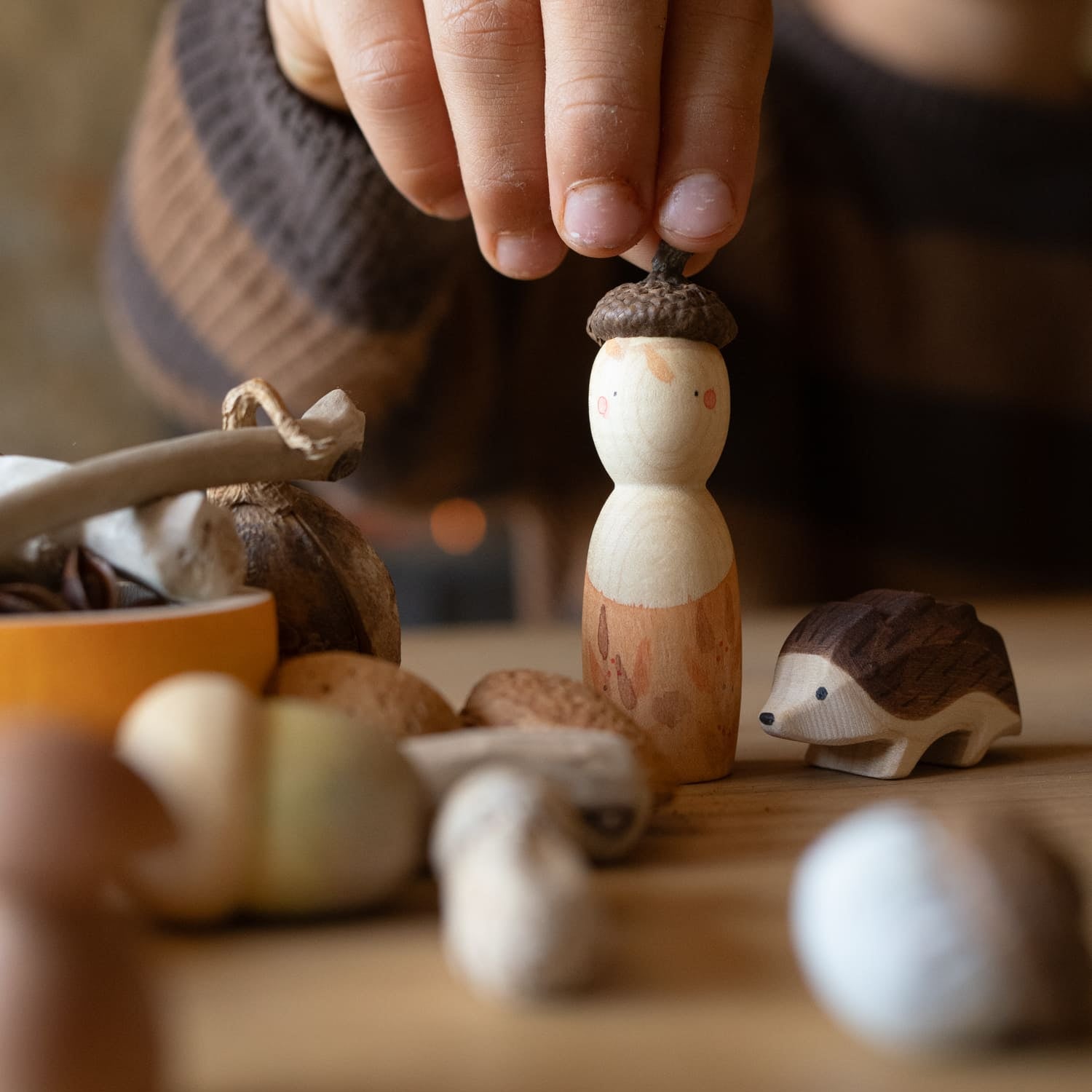 child playing with grapat ostheimer hello autumn wooden toy set with nin peg doll, mushrooms, flower press, and hedgehog