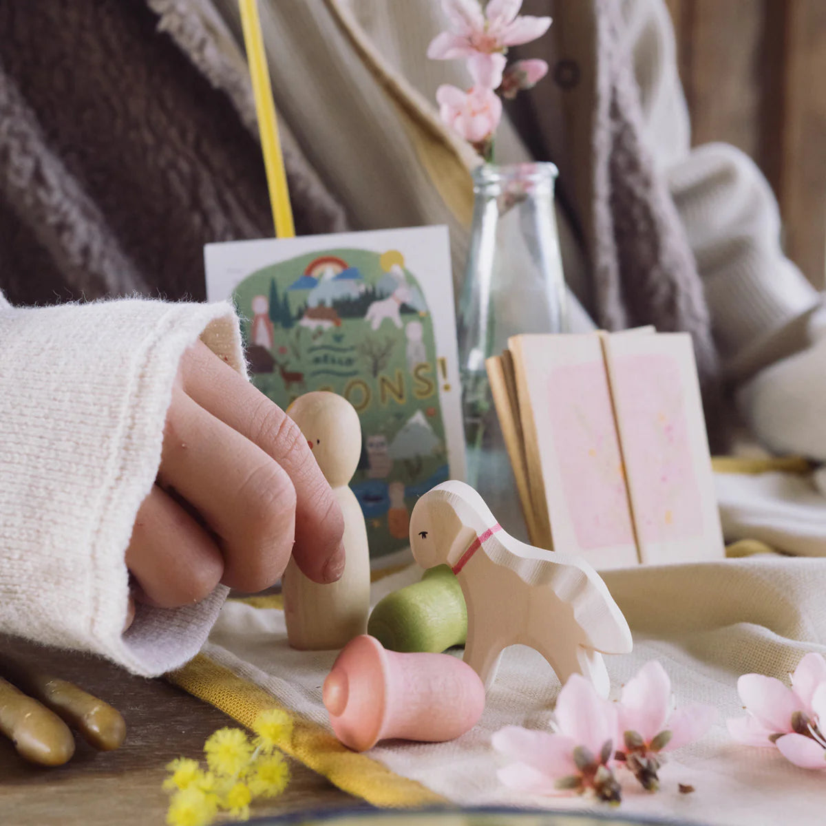 child playing with grapat and ostheimer wooden hello spring toy set with lamb, nin, acorns and flower press