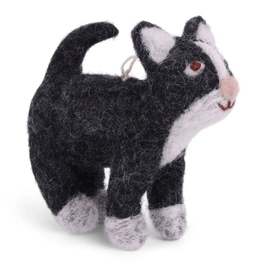 A hand-felted wool miniature toy cat in gray and white with a small pink nose and brown eye.