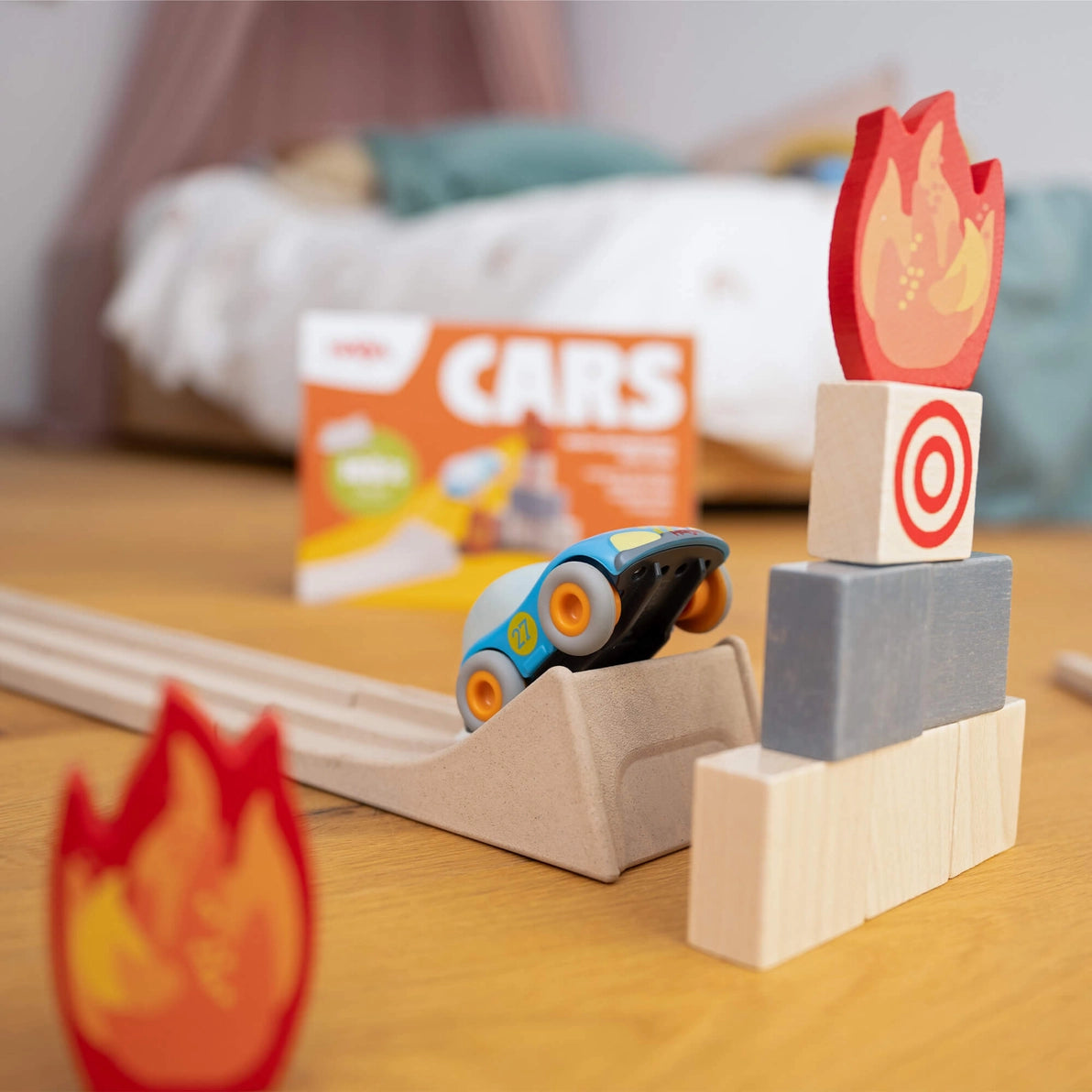Haba car driving up a wooden ramp to make a stunt jump