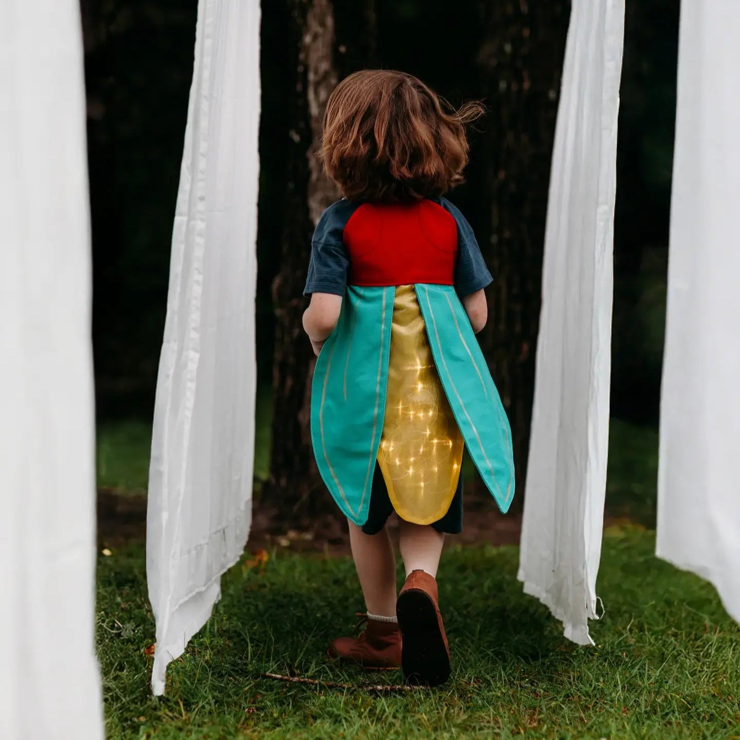 a child in light-up firefly costume wings