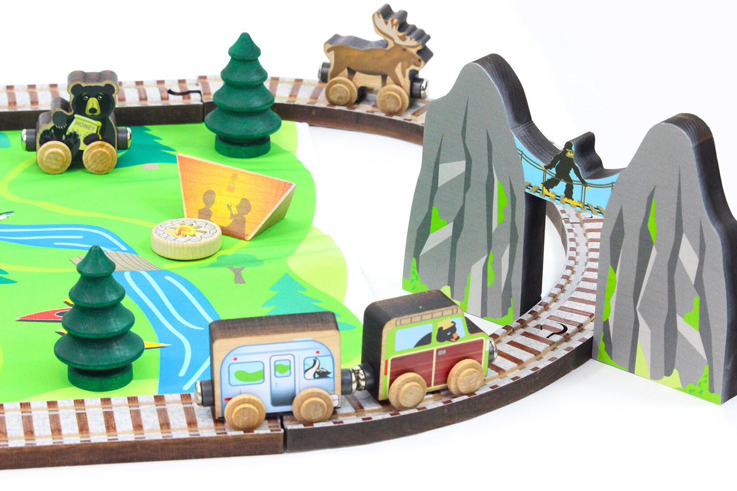 Maple Landmark toy train set with tracks, a mountain pass, trees, and animals .