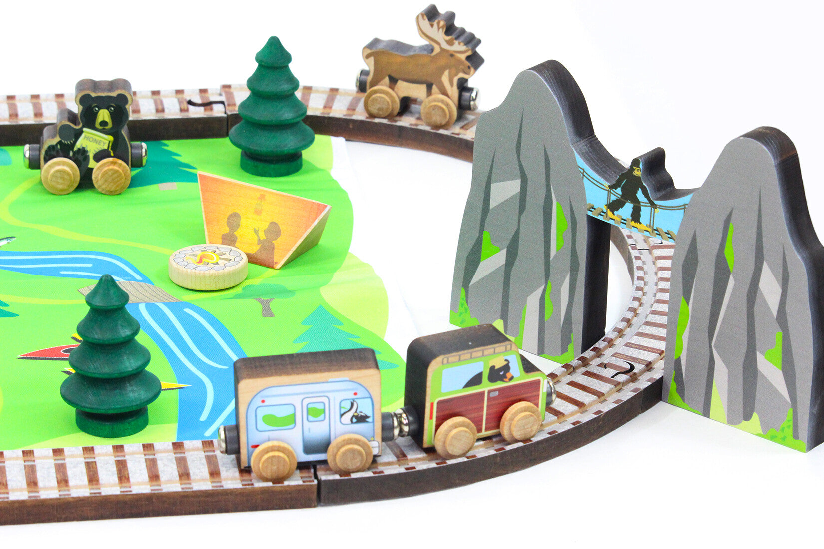 Maple Landmark toy train set with tracks, a mountain pass, trees, and animals .