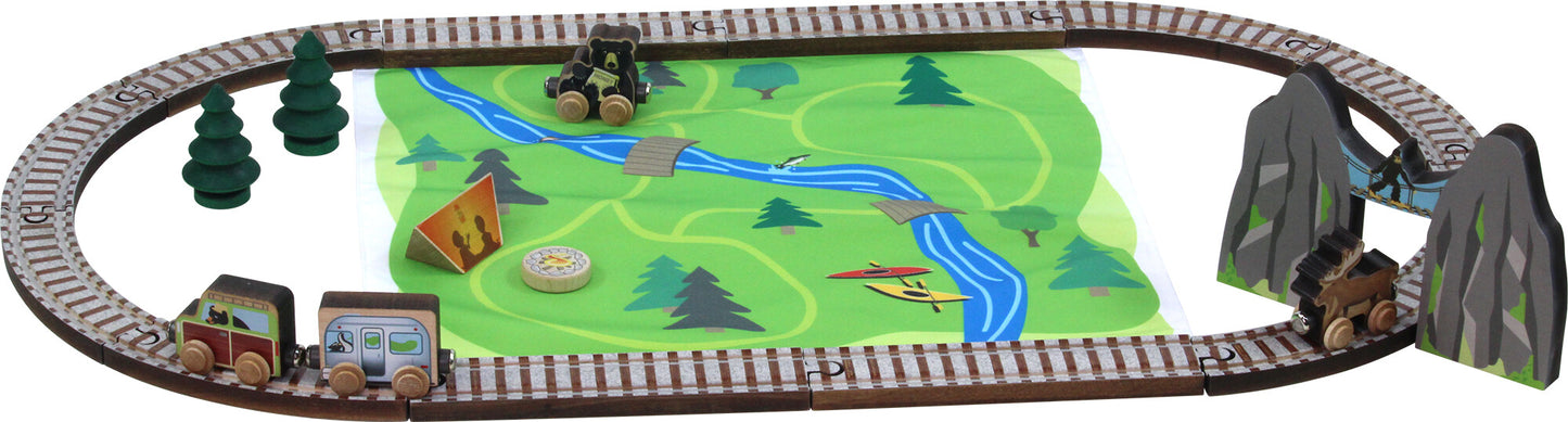 Maple Landmark toy train set with tracks, train cars, trees, a mountain pass, a tent, and a playmat