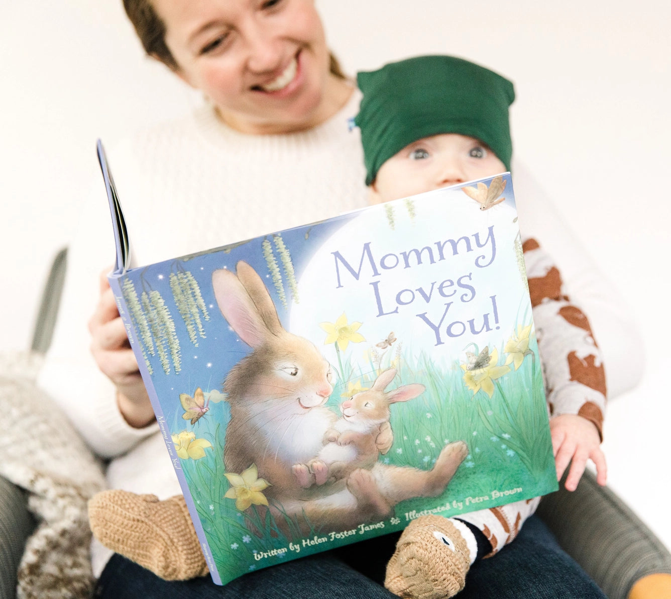Woman reading 'Mommy Loves You!' picture book to a child