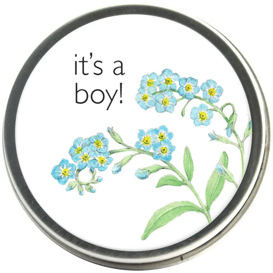 Round tin of forget-me-not flower seeds with 'it's a boy!' and blue flower illustrated label