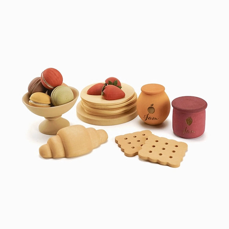 Sabo Concept set of wooden play food dessert items including a croissant, crepes, fruit, and jars.