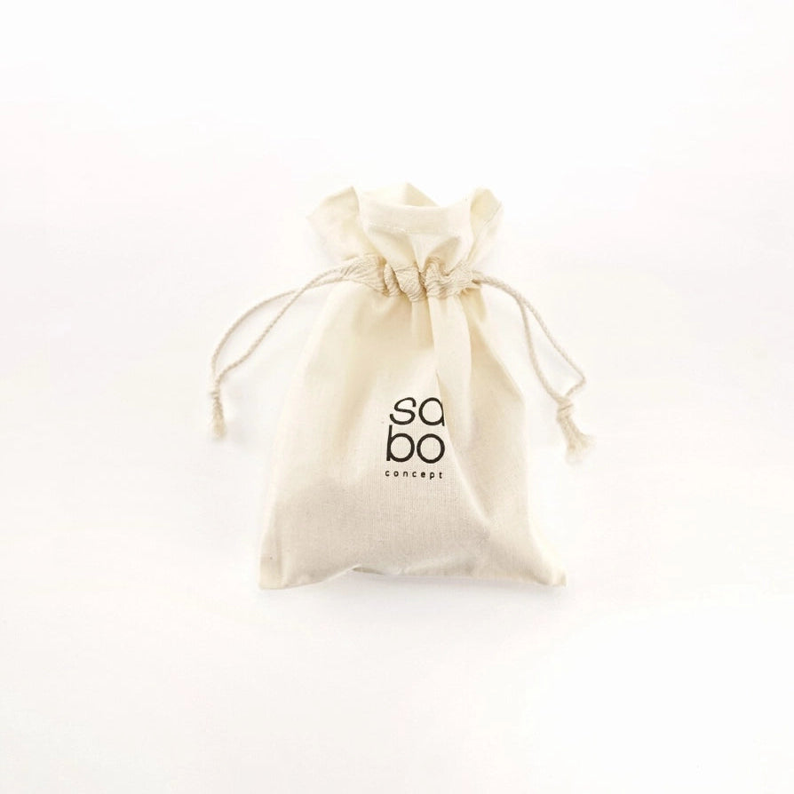 A Sabo Concept cotton drawstring pouch for wooden play food dessert set