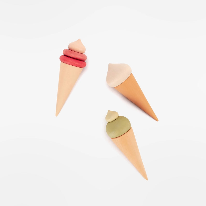 Sabo Concept three wooden play food ice cream cones in pink, white and green.