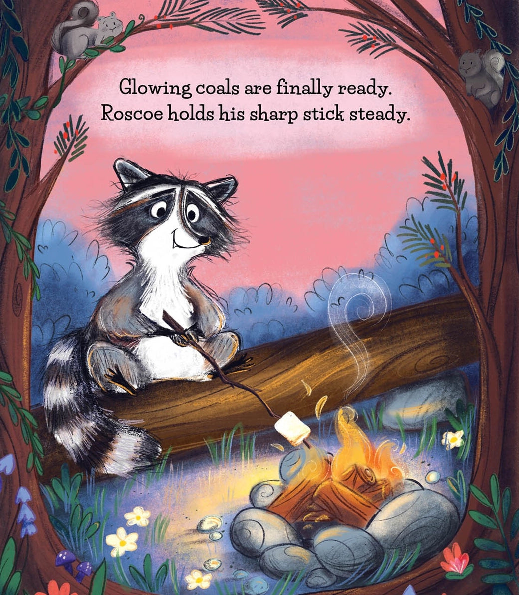 Make More S'mores children's book illustrated page  with a raccoon sitting on a log by a campfire, roasting a marshmallow with a stick. Trees and foliage frame the artwork, with a pink sky and the text, 'Glowing coals are finally ready.