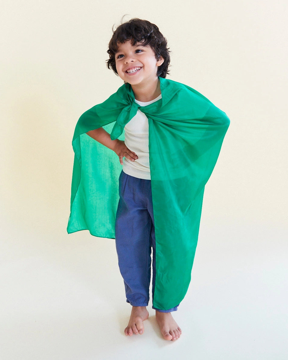Boy wearing Sarah's Silks Emerald green playsilk as a cape