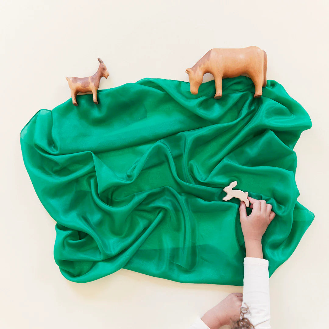 A Sarah's Silks emerald green playsilk as a forest floor in a small world animal scene. 
