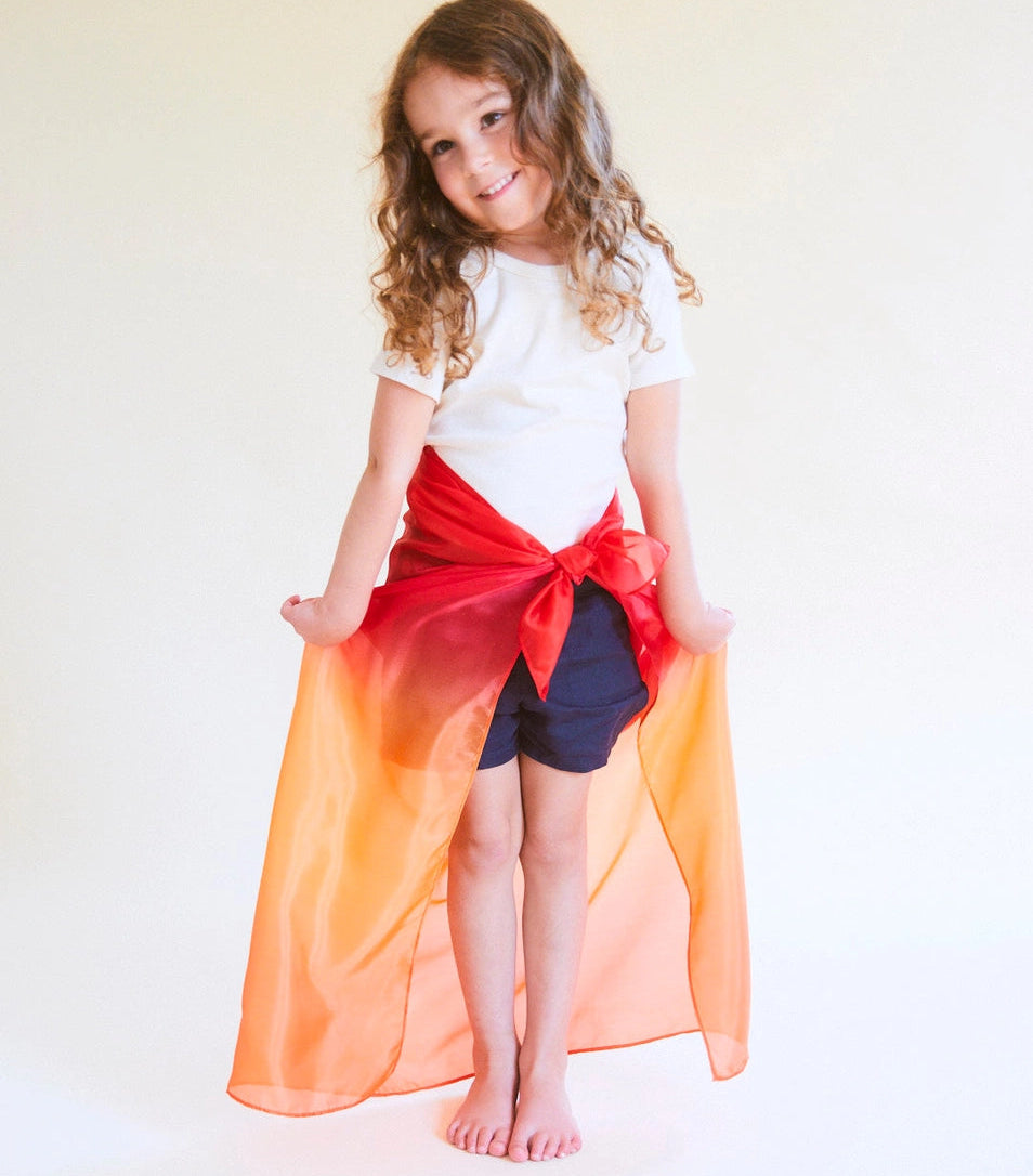 a girl wearing a Sarah's Silks fire enchanted playsilk as a skirt