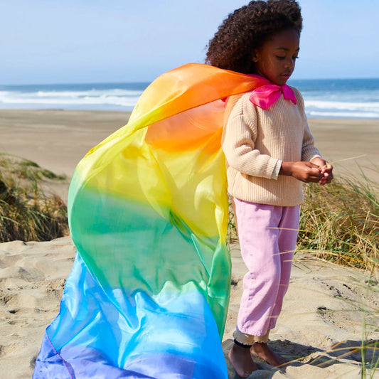 Child with a Sarah's Silks giant rainbow playsilk