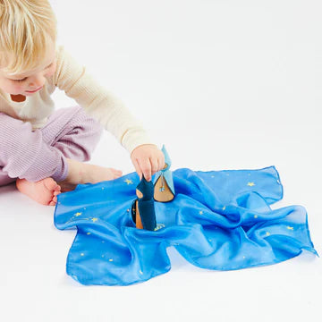 Girl playing with Sarah's Silks mini starry night playsilk as a space playscape with figures