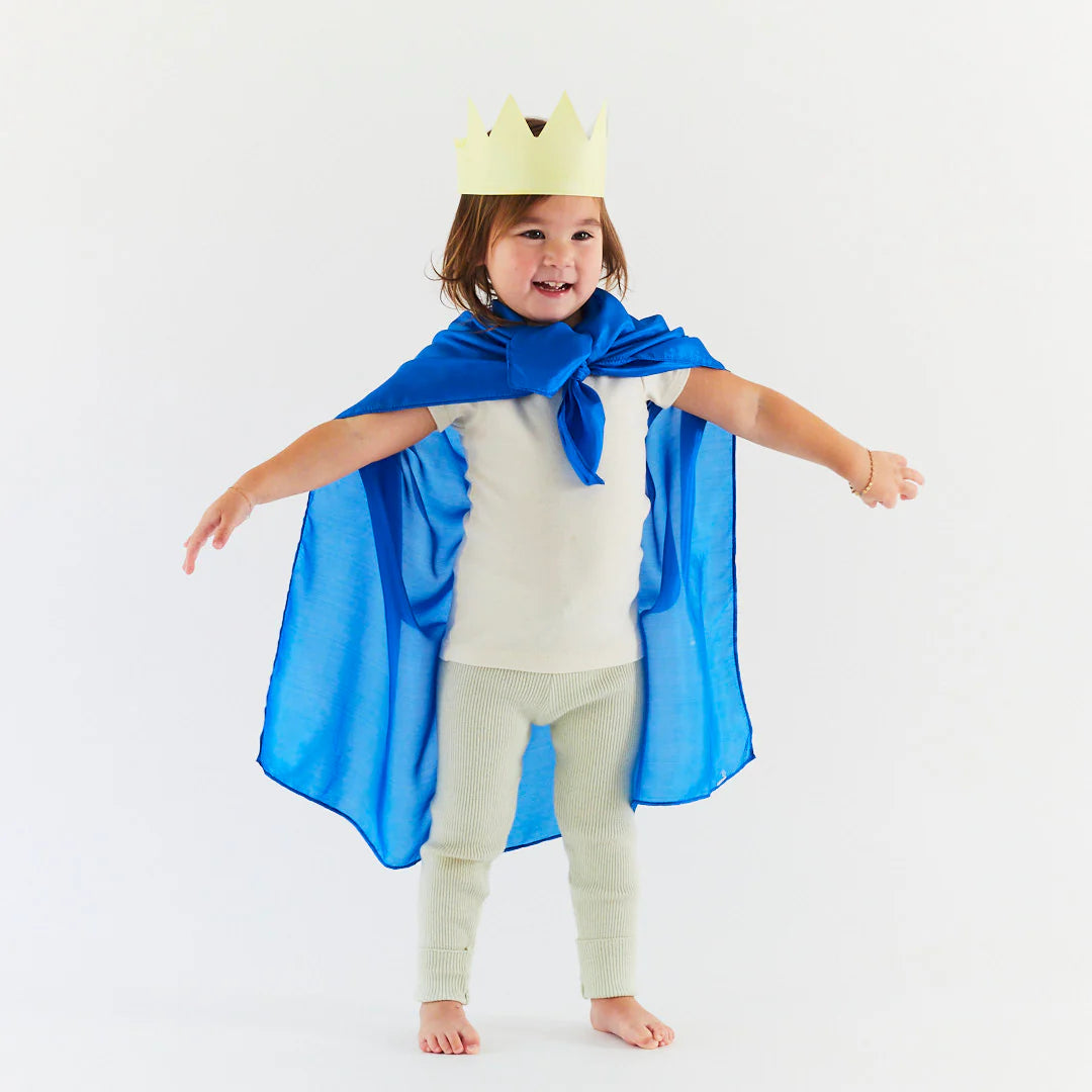 Child wearing a solid blue Sarah's Silks playsilk as a royal cape. 
