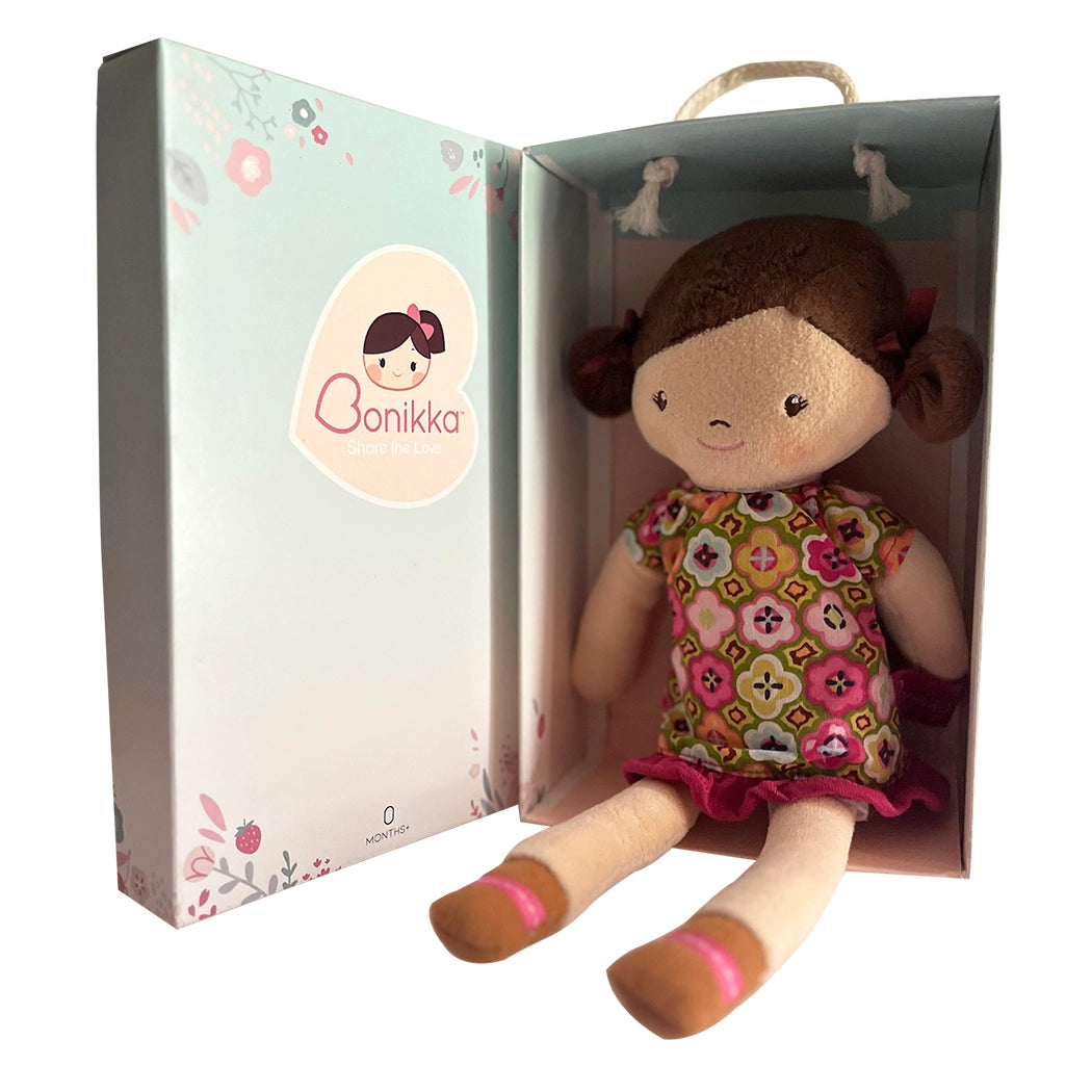 Bonikka handmade rag doll with light skin, brown hair and brown eyes wearing a floral dress in a gift box