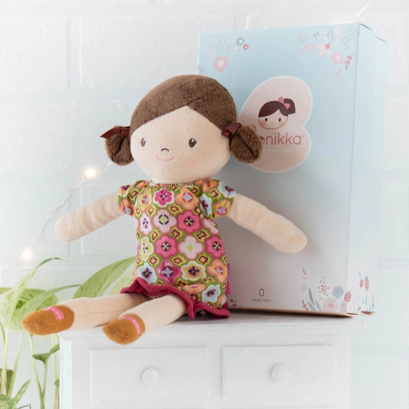 handmade rag doll with brown hair and eyes and a floral dress
