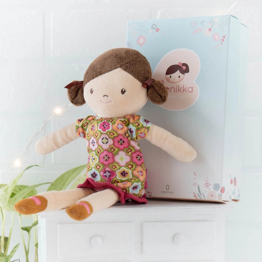 handmade rag doll with brown hair and eyes and a floral dress