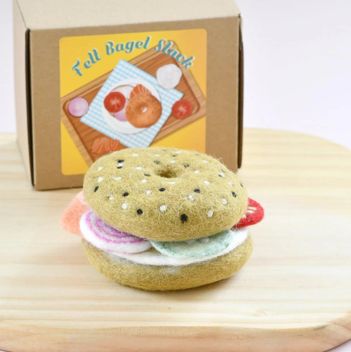 Tara Treasures Felt play food bagel stack toy with a cardboard box featuring bagel illustrations