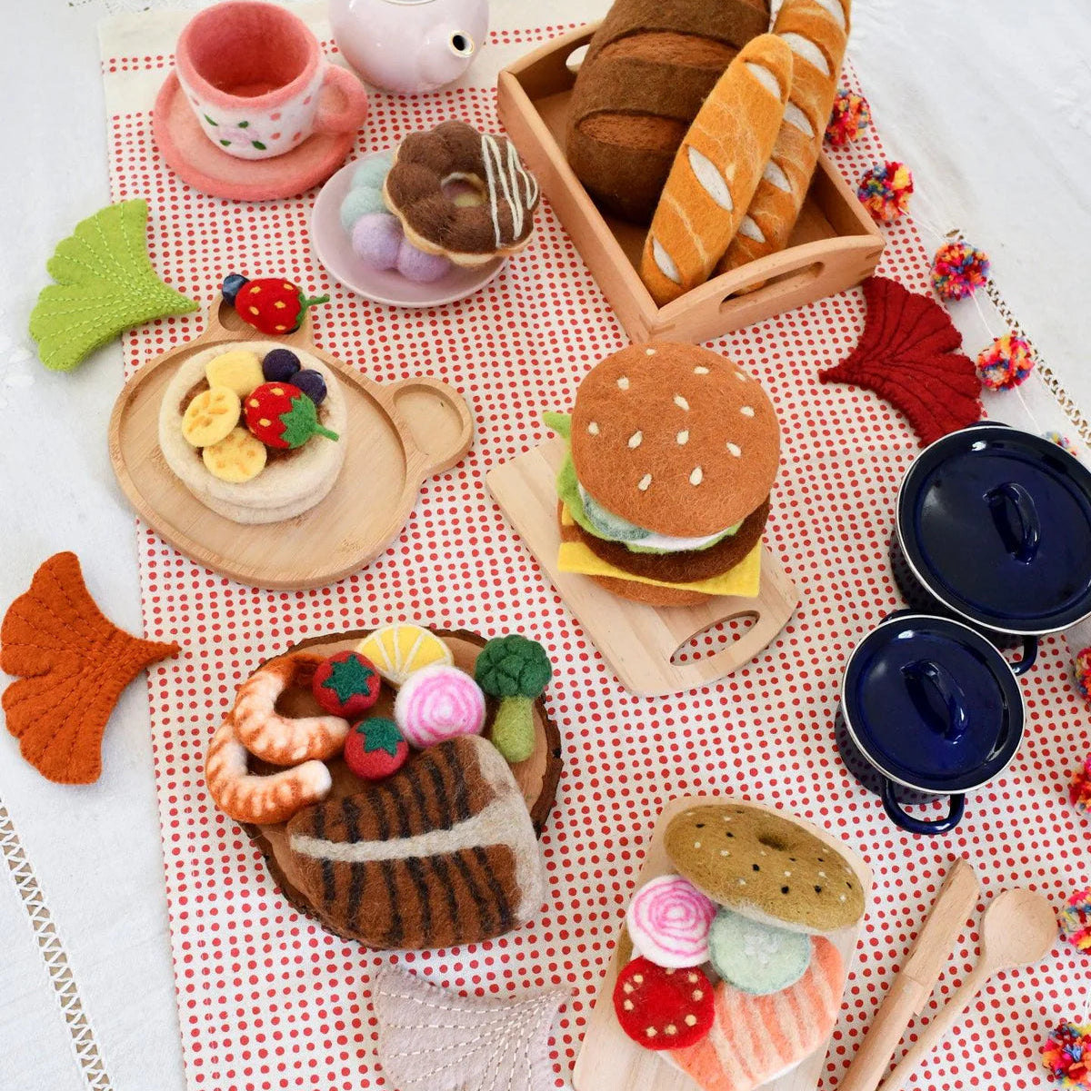 Tara Treasures felt play food featuring tea cup, pancakes, breads, donuts, surf and turf, hamburger, and bagel sandwich. 