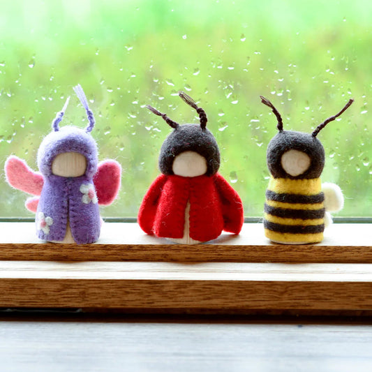 Three Tara Treasures felt and wood peg dolls representing a butterfly, ladybug, and bee.