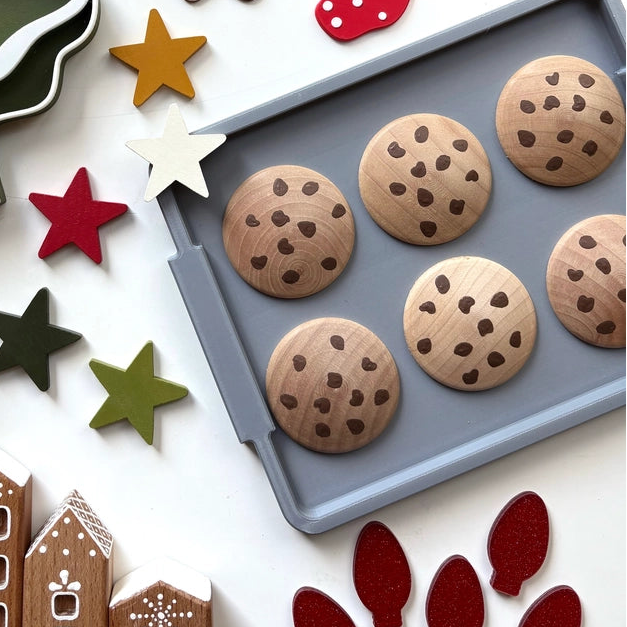 handmade wooden play food chocolate chip cookies on a baking sheet