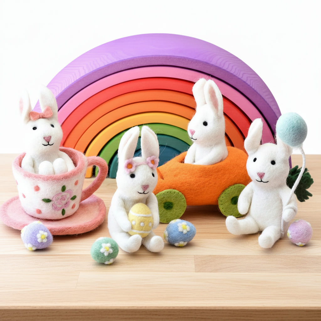 Felt easter bunny toys with colorful eggs and a wooden rainbow 