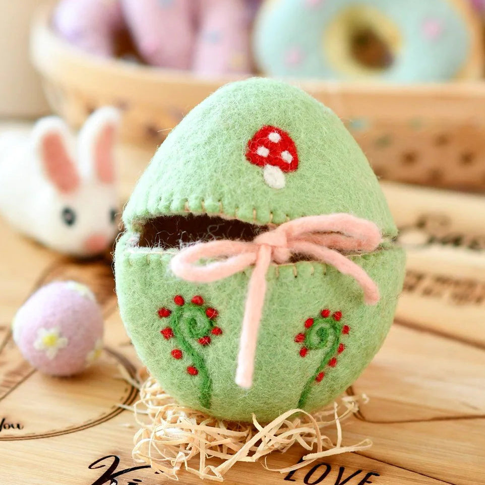 Green embroidered egg cover with a pink bow and a mushroom for small kid's Easter gifts