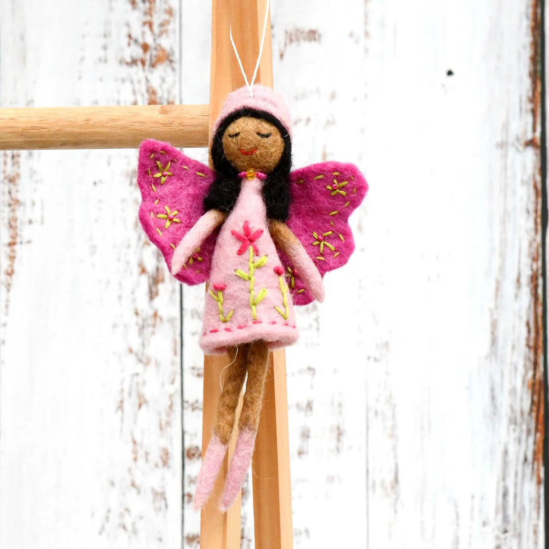 Tara Treasures felt fairy with pink wings, brown skin and black hair, wearing a flower embroidered light pink dress