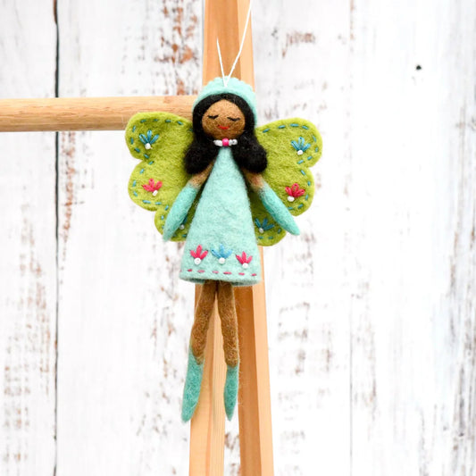 Tara Treasures felt fairy with green wings, brown skin and black hair, wearing a turquoise dress embroidered with flowers