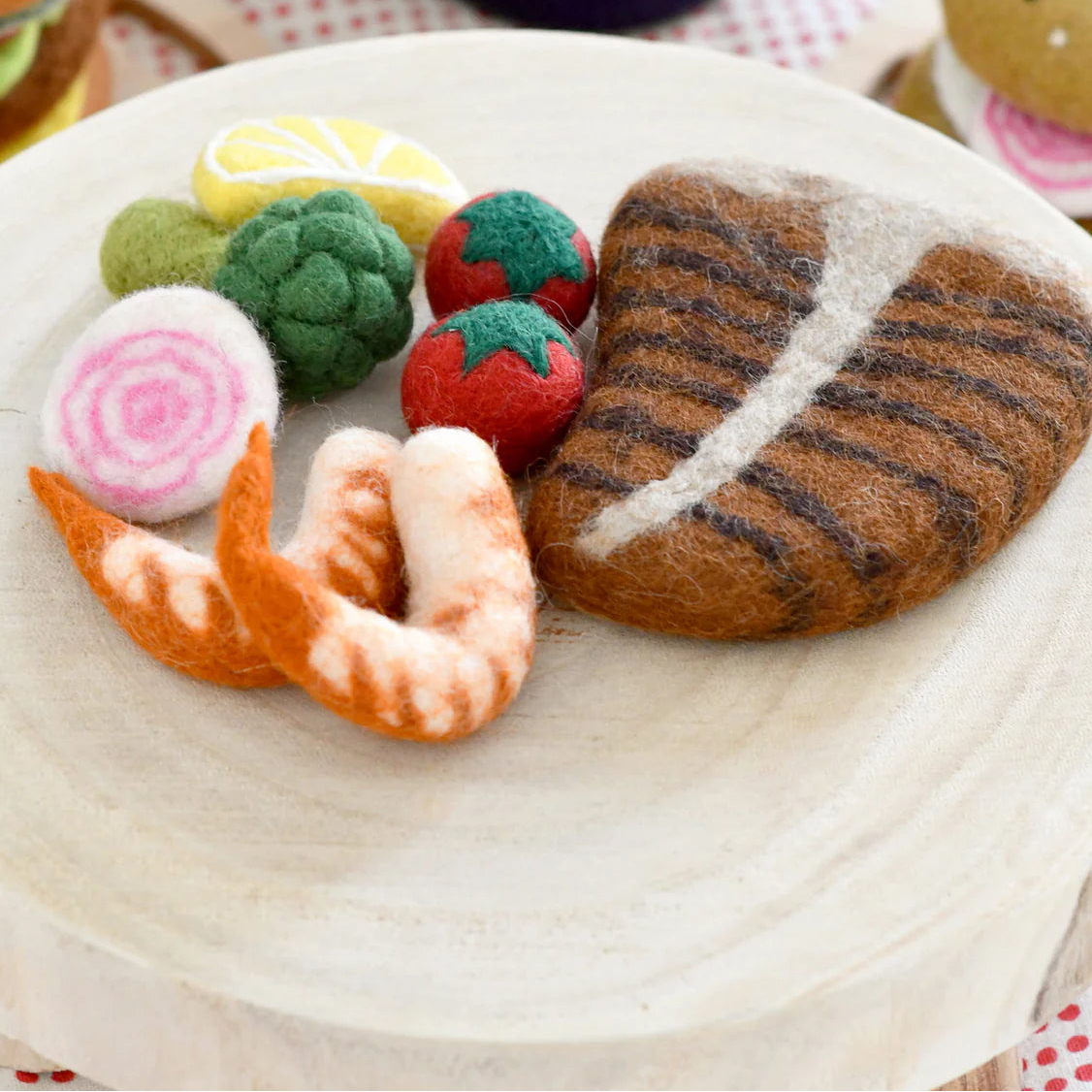 Tara treasures felt food toys including a steak, shrimp, and vegetables.