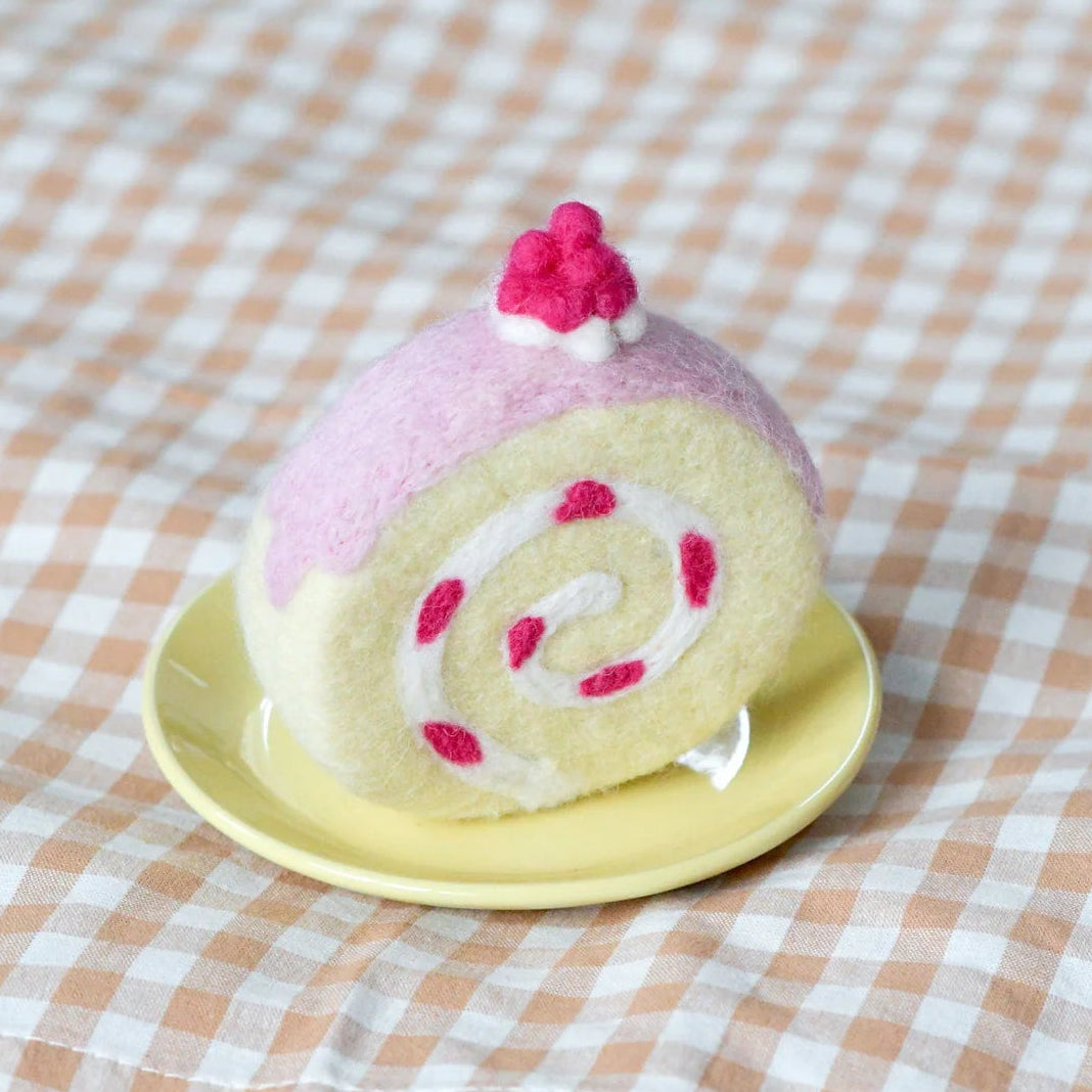 felt strawberry swiss roll play food toy cake on a yellow plate with a checkered tablecloth 