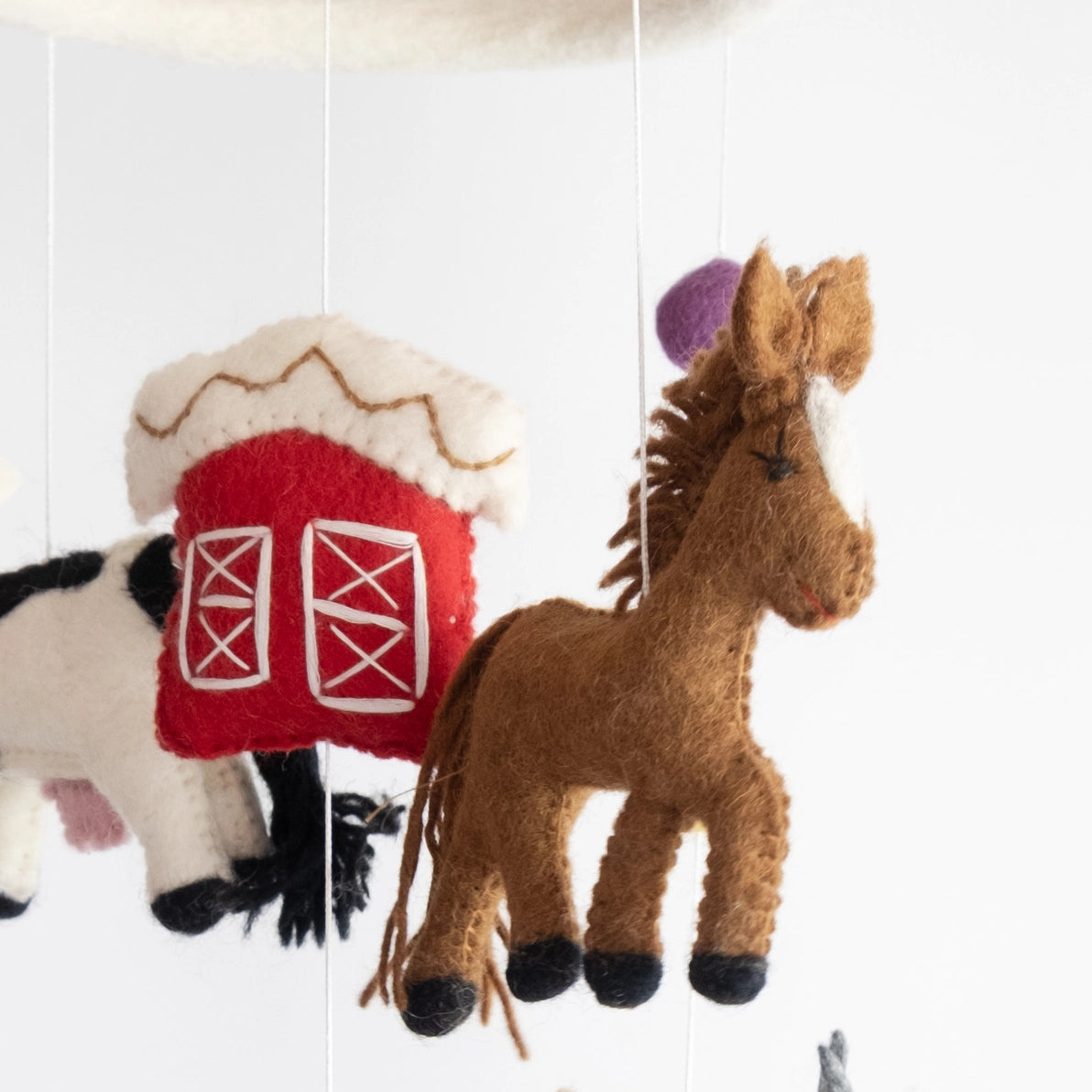 Felt baby and children's nursery mobile with a red barn and horse.