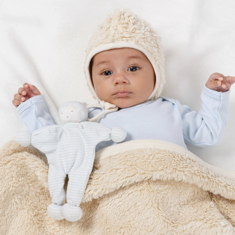 Baby holding Under the Nile Baby Buddy Lovey Doll in blue stripes