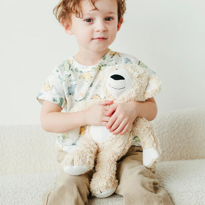 toddler boy holding the under the nile organic sherpa bear stuffed animal