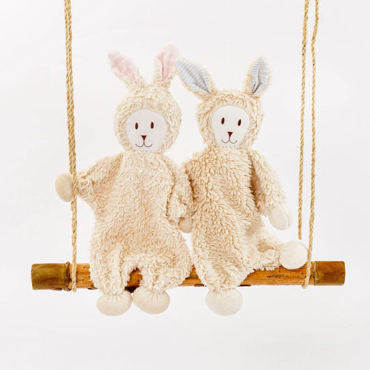 Under the Nile Organic Sherpa Snuggle Bunny baby stuffed animals on a swing