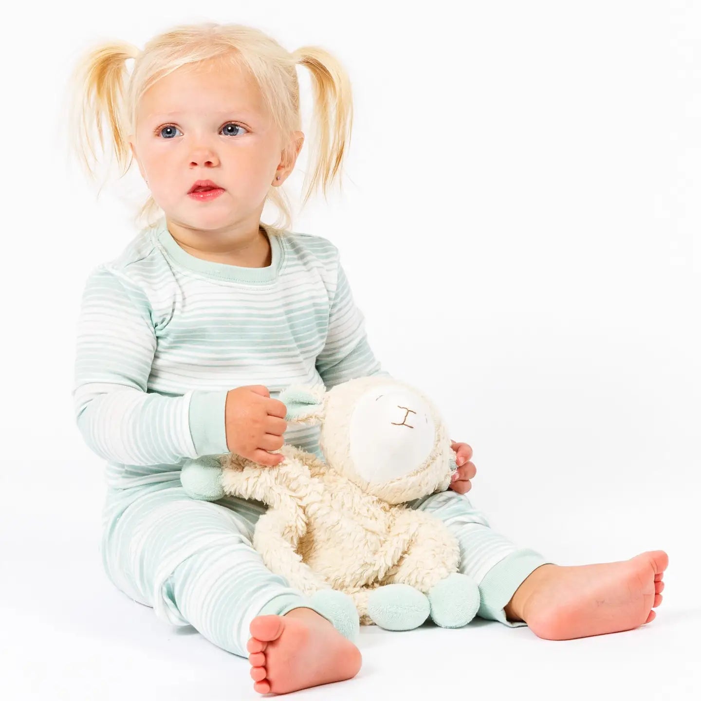 toddler with under the nile organic baby snuggle sheep toy