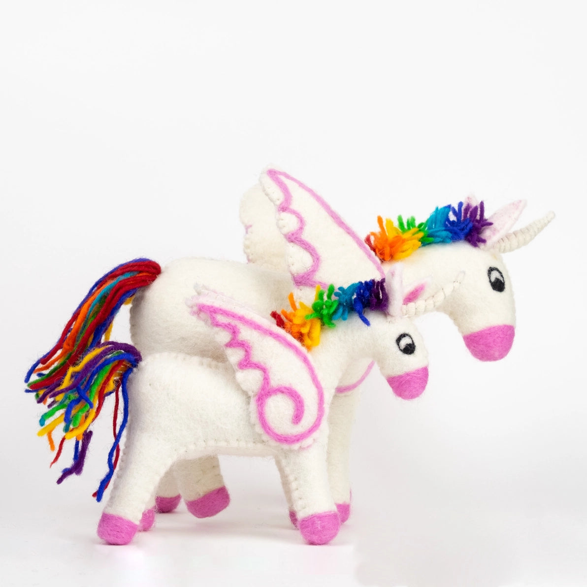 felted unicorn toy with rainbow hair and tail on a white background