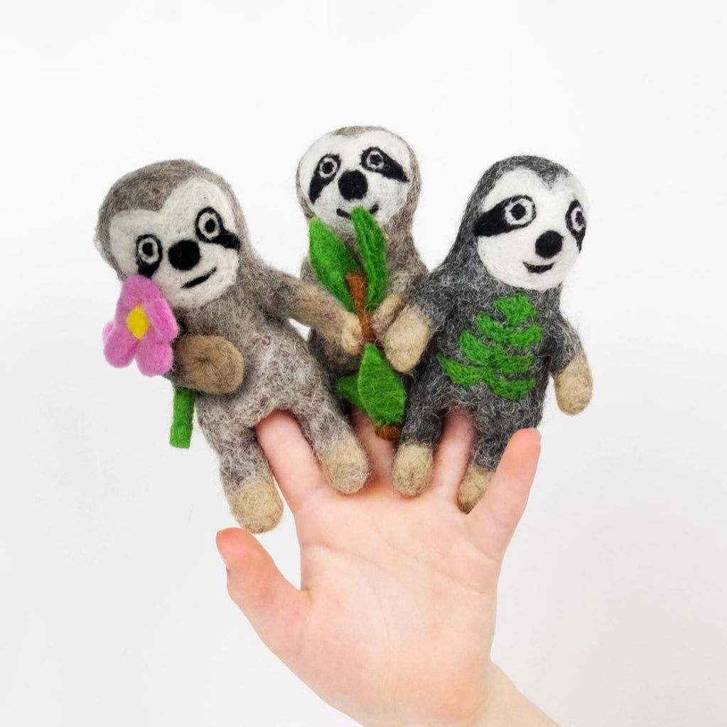 handmade felt sloth finger puppets with flower, leaf, and branch