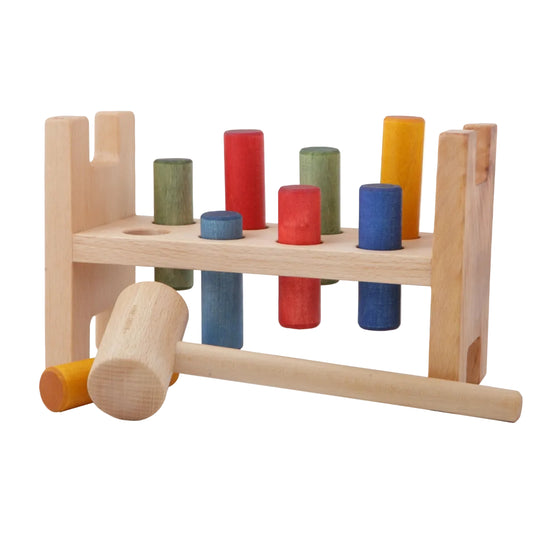 Wooden story Pound-a Peg natural wood toy with a hammer and rainbow colored pegs.