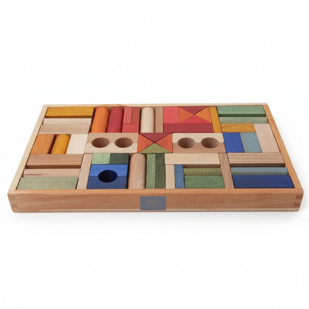 Wooden story rainbow toy blocks in a natural wood tray